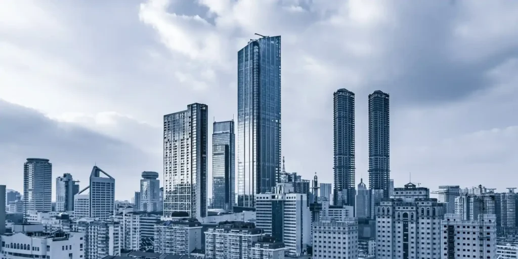 The Hong Kong skyline, with its towering skyscrapers, towers over