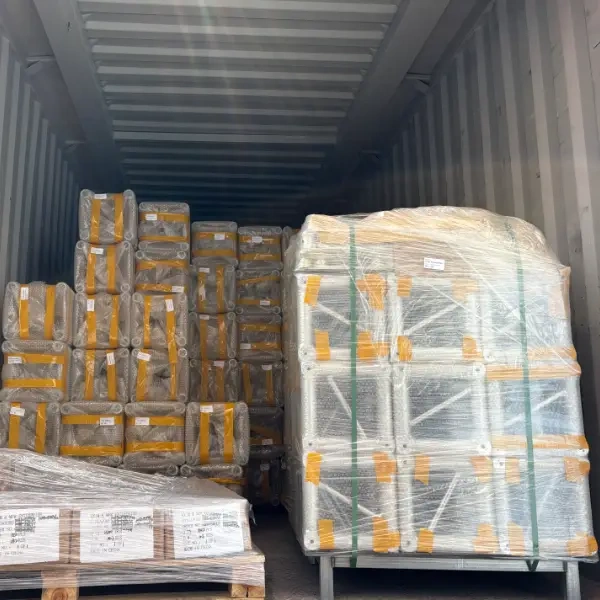 A shipping container loaded with stacks of aluminum alloy trusses, each wrapped in double - layer bubble film and secured with straps, ready for export.