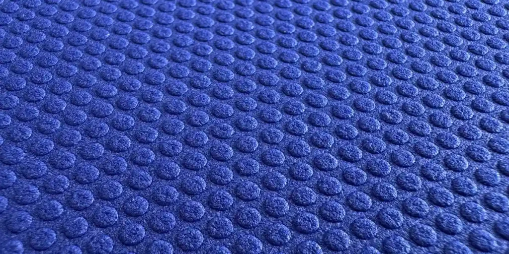 An EVA foam sheet with a dot - pattern hot - embossed, thermoformed and coated surface.