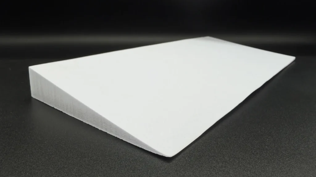 White wedge-shaped EVA foam part, 280 mm long, tapering from 25 mm to 1 mm, produced by bevel cutting
